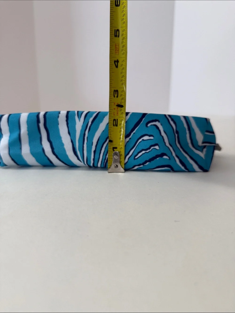 Estee Lauder Turquoise and White Zebra-Print Cosmetic Pouch with Lion Charm